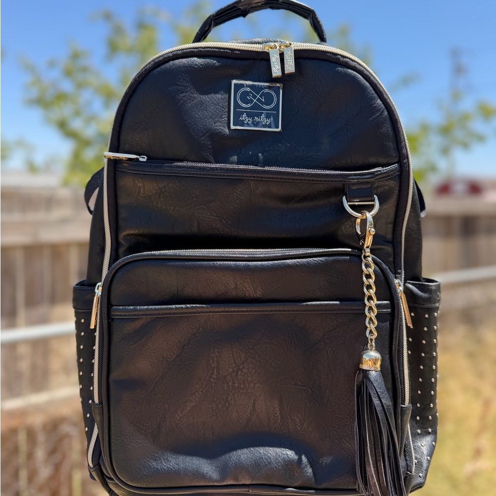 Itzy Ritzy Chelsea Black Faux Leather Backpack with Gold Tassel Accent
